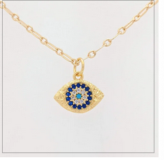 Gold necklace with an eye-shaped pendant featuring blue stones on a white background
